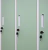 Close-up view of three green metal lockers with silver handles and keys. Produktbild-Vorschau