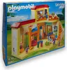 A Playmobil playset box showing a colorful building with figures. Produktbild-Vorschau