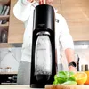 A person is using a SodaStream machine in a kitchen setting. Produktbild-Vorschau