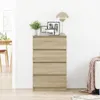 A wooden dresser with four drawers is shown in a room with a lamp and framed pictures on top. Anteprima dell’immagine prodotto