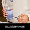 A person is holding a portable blender and connecting a charging cable. Náhled obrázku produktu
