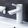 A white bathroom faucet and soap dish are shown against a dark gray tiled wall and a white countertop. Produktbild-Vorschau