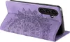 A purple flip case for a smartphone, with a mandala design embossed on the cover. The phone is visible inside the case. Produktbild-Vorschau