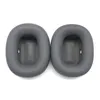 Two gray ear pads for headphones are shown against a white background. Produktbild-Vorschau