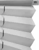 A close-up view of a gray pleated blind, showing its texture and folded structure. Produktbild-Vorschau