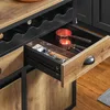 A close-up view of kitchen storage drawers, showing wine bottle holders and kitchen utensils. Produktbild-Vorschau