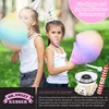 Two young girls wearing party hats are enjoying cotton candy. A cotton candy machine and accessories are shown in the lower right corner, along with text overlays advertising the product. Produktbild-Vorschau