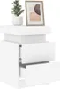 A white nightstand with two drawers, a potted plant, and a framed picture on top. Anteprima dell’immagine prodotto