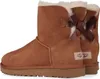 A pair of brown Ugg boots with bows on the back, shown from the side. Produktbild-Vorschau