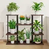 A multi-tiered plant stand filled with various potted plants, placed against a white wall. Podgląd zdjęcia produktu