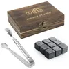 A wooden box with whiskey stones and tongs on a white background. Produktbild-Vorschau