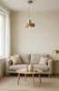 A modern living room scene with a sofa, coffee table, and a pendant lamp. Produktbild-Vorschau