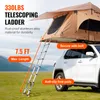 A rooftop tent is set up on a car in a grassy field with mountains in the background. Anteprima dell’immagine prodotto