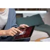 A person is using a tablet device in a living room setting. Produktbild-Vorschau