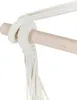 A close-up of a rope knot securing a hammock chair to a wooden bar. Náhled obrázku produktu