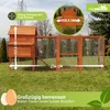 A wooden chicken coop with an attached run, set up on a grassy lawn. Produktbild-Vorschau