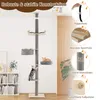 A multi-level cat tree with scratching posts and platforms, shown in a room setting with furniture and plants. Produktbild-Vorschau