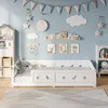 A child's bedroom with a white bed, decorations, and storage. Voir les images du produit