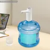 A water cooler bottle with an electric pump attached, next to a glass and a laptop screen displaying a hand pouring liquid. Podgląd zdjęcia produktu