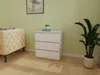 A white dresser with three drawers is placed next to a beige upholstered bench in a room with light green walls and a wooden floor. A potted plant is visible to the right of the dresser. Náhled obrázku produktu