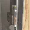 A close-up view of a shower door handle and frame, with a glimpse of a shower enclosure and wooden wall. Produktbild-Vorschau