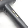 A close-up of a dark gray hairdryer with gold buttons and a pink asterisk symbol. Podgląd zdjęcia produktu