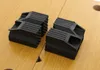 Two black rubber clamps are placed on a wooden surface. Náhled obrázku produktu