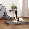 A dog is lying on a dog mat in a living room setting. Anteprima dell’immagine prodotto
