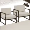 Two cream-colored outdoor lounge chairs with dark gray frames are shown against a light gray textured background. Water droplets are visible in the upper left corner, suggesting the fabric is water-resistant. Náhled obrázku produktu