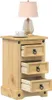 A wooden nightstand with three drawers, a cup and saucer on top, and a lamp. Produktbild-Vorschau