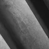 A close-up, abstract view of gray fabric folds. Produktbild-Vorschau