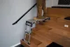 A person stands on a portable work platform on a wooden staircase. Anteprima dell’immagine prodotto
