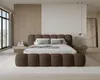 A modern bedroom with a large bed, nightstands, and a large window. Voir les images du produit
