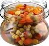 A close-up of a glass jar filled with pickled vegetables, with two other empty jars in the background. Náhľad obrázku produktu