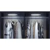 Two closet sections with clothes hanging on hangers, illuminated by LED lights. Produktbild-Vorschau