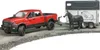 A red toy truck towing a horse trailer with a toy horse. Produktbild-Vorschau