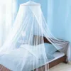 A mosquito net canopy is draped over a bed in a bedroom. Náhled obrázku produktu