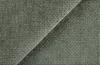 A close-up view of green chenille fabric with a woven texture. Produktbild-Vorschau