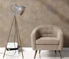 A floor lamp and an armchair are placed in front of a textured wall. Produktbild-Vorschau
