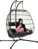 A woman sits in a hanging egg chair. Produktbild-Vorschau