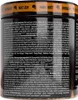 A close-up view of the side of a black supplement container with orange and white text and graphics. Voir les images du produit