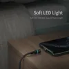 A charging cable with a blue LED light is shown next to a smartphone on a wooden nightstand. Produktbild-Vorschau