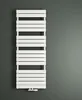 A white radiator is mounted on a dark gray wall. Produktbild-Vorschau