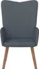 A front view of a dark gray velvet armchair with wooden legs against a white background. Náhled obrázku produktu