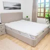 A bedroom scene with a bed, headboard, and nightstand. Náhled obrázku produktu