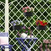 A garden scene with hanging flower pots on a trellis, a table, and a chair. Produktbild-Vorschau