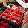 A close-up view of an open tool organizer box filled with various hardware and tapes. Anteprima dell’immagine prodotto