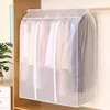 A garment bag hanging in a closet with clothes inside. Produktbild-Vorschau