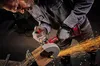 A person using an angle grinder to cut metal, creating sparks. Produktbild-Vorschau