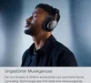 A man wearing headphones with his eyes closed, appearing to enjoy music. Produktbild-Vorschau